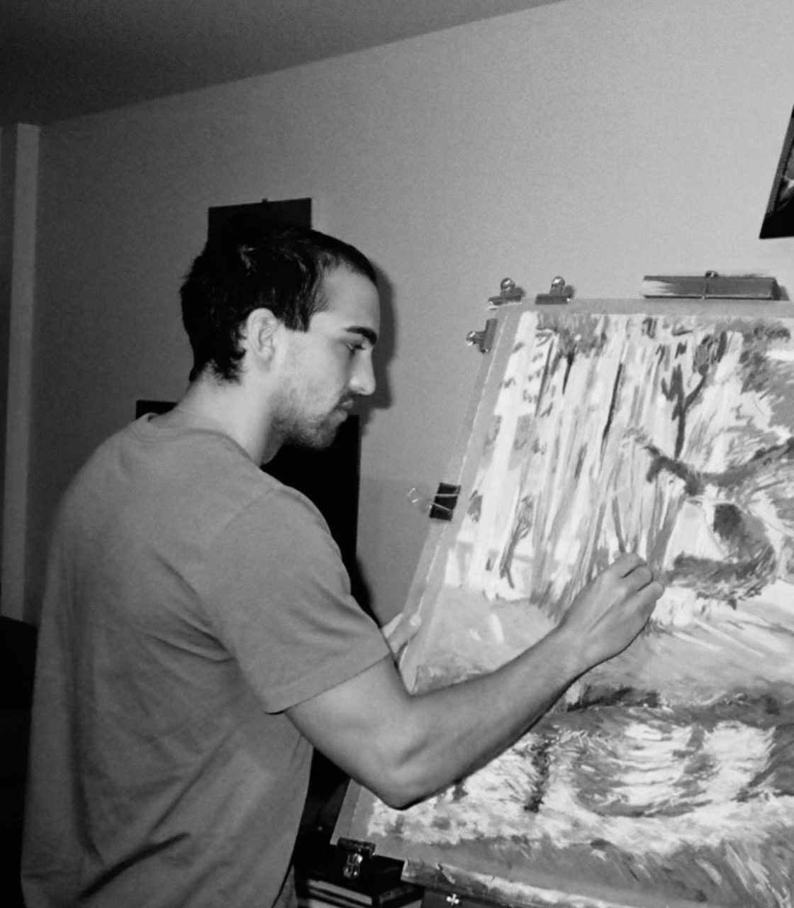Téo Obré painting at his easel in the studio